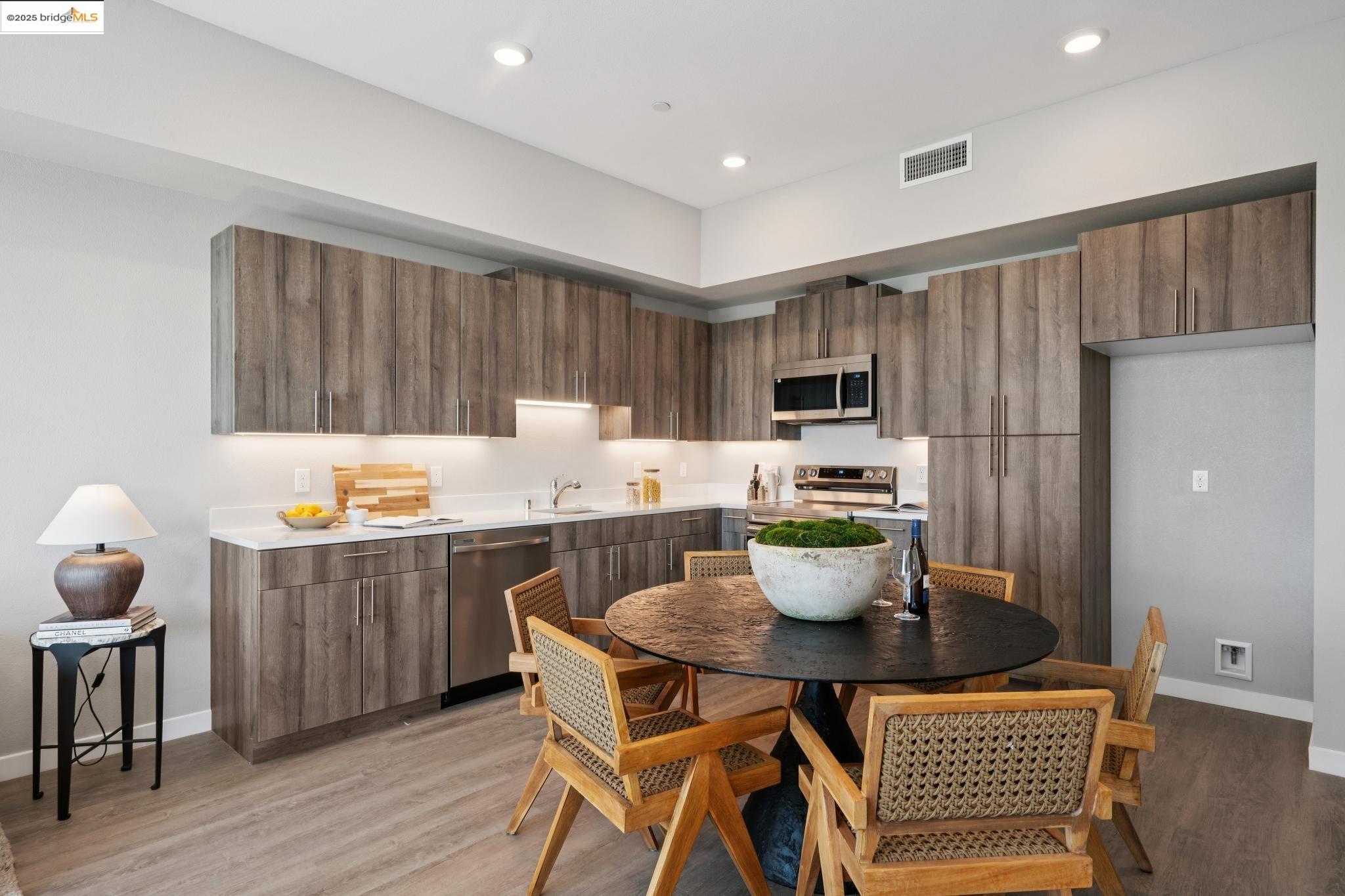 2400 Adeline Street, Unit 403 Oakland, CA 94607 - Photo 9 of 25 a kitchen with a dining table and chairs