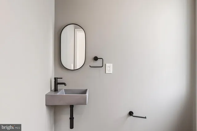 a bathroom with a double vanity sink a mirror and a bathtub