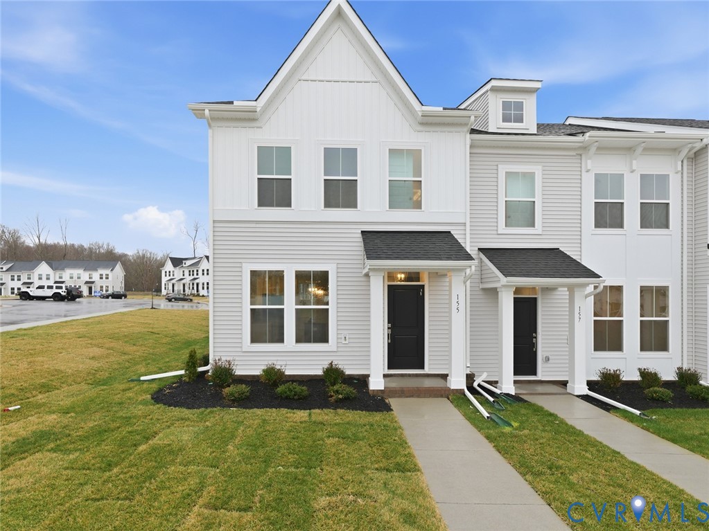 a front view of a house with yard and garage