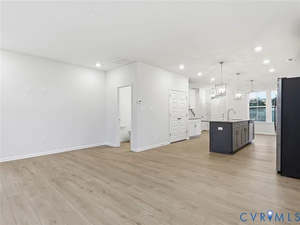 a view of a kitchen with a sink and a refrigerator