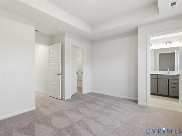 an empty room with a bathroom and a sink