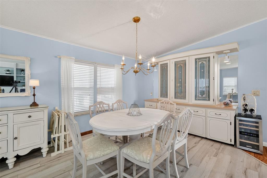 3567 Manatee Road Tavares, FL 32778 - Photo 11 of 45 a view of a dining room with furniture window and wooden floor