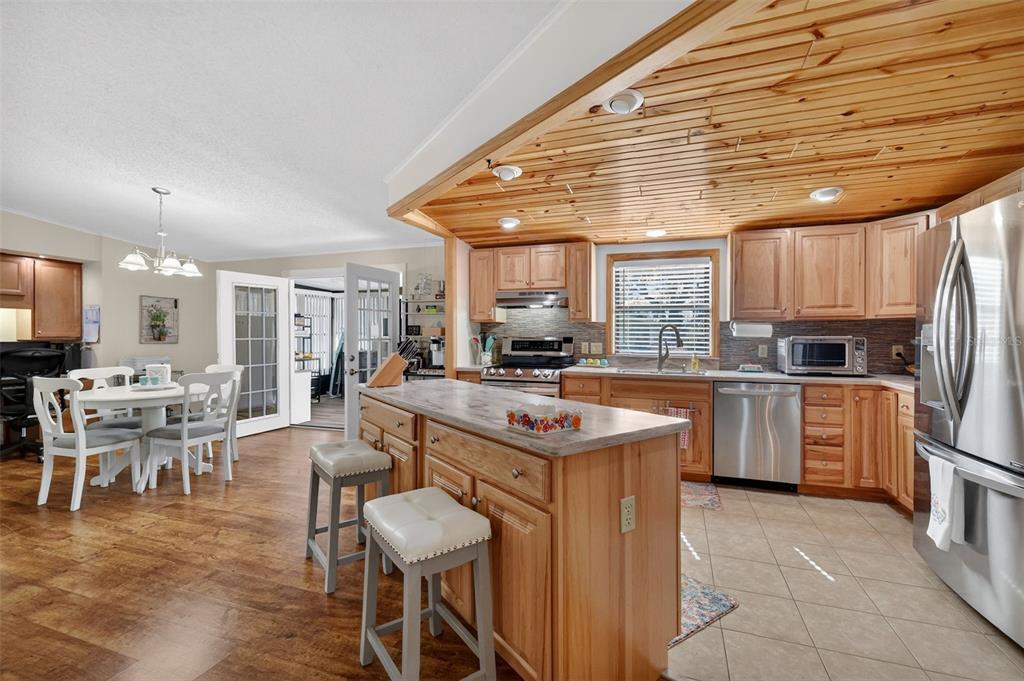 3567 Manatee Road Tavares, FL 32778 - Photo 12 of 45 a kitchen with stainless steel appliances granite countertop a sink and cabinets