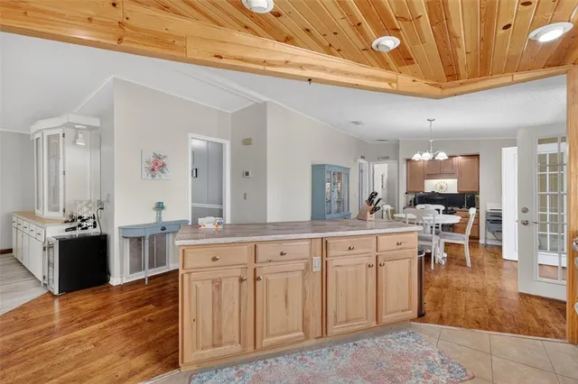 a large white kitchen with lots of counter space and painting on the wall