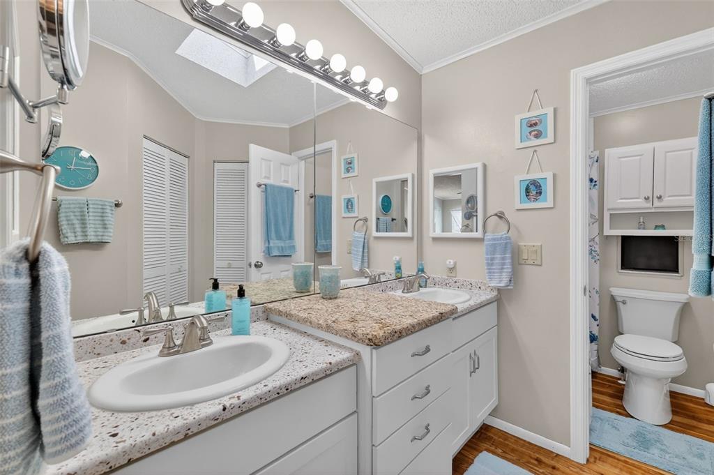 3567 Manatee Road Tavares, FL 32778 - Photo 16 of 67 a spacious bathroom with a granite countertop double vanity sink a mirror and a toilet