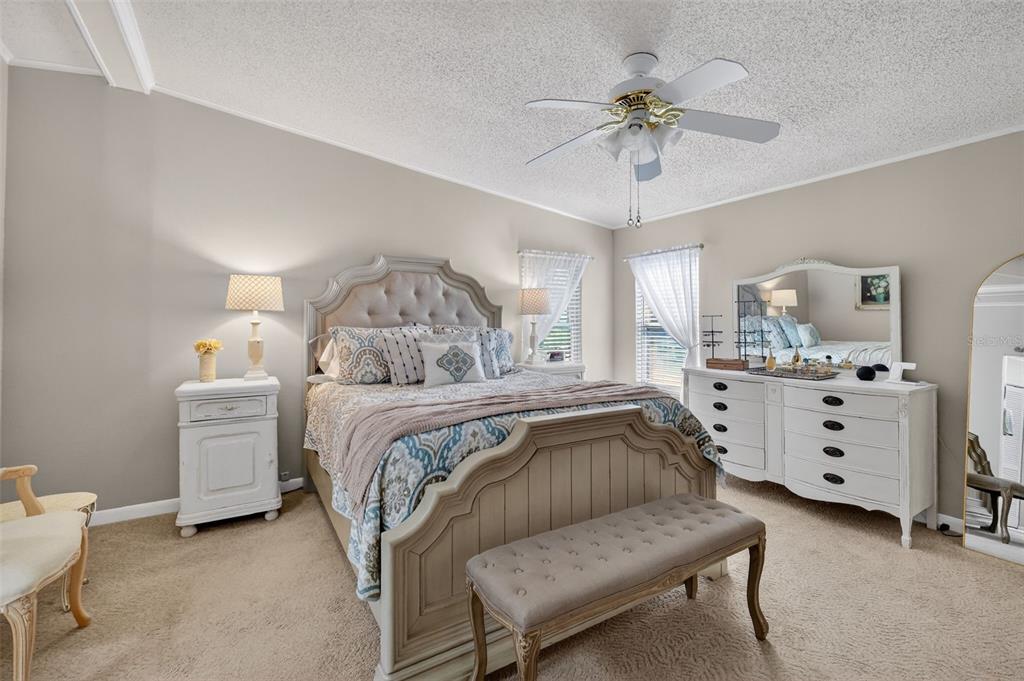 3567 Manatee Road Tavares, FL 32778 - Photo 17 of 45 a bedroom with a bed and a chandelier