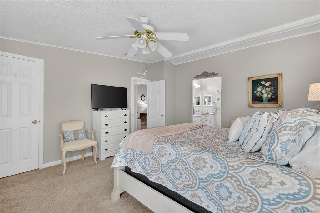 3567 Manatee Road Tavares, FL 32778 - Photo 18 of 45 a bedroom with a large bed and a flat screen tv
