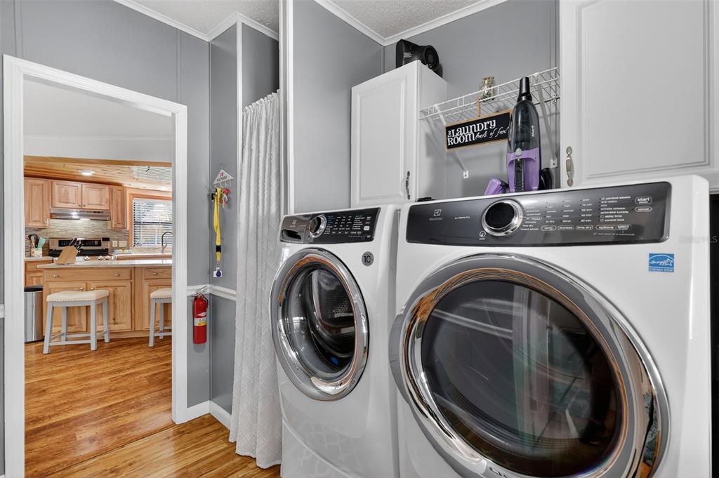3567 Manatee Road Tavares, FL 32778 - Photo 21 of 67 a view of a storage & utility room with wooden floor