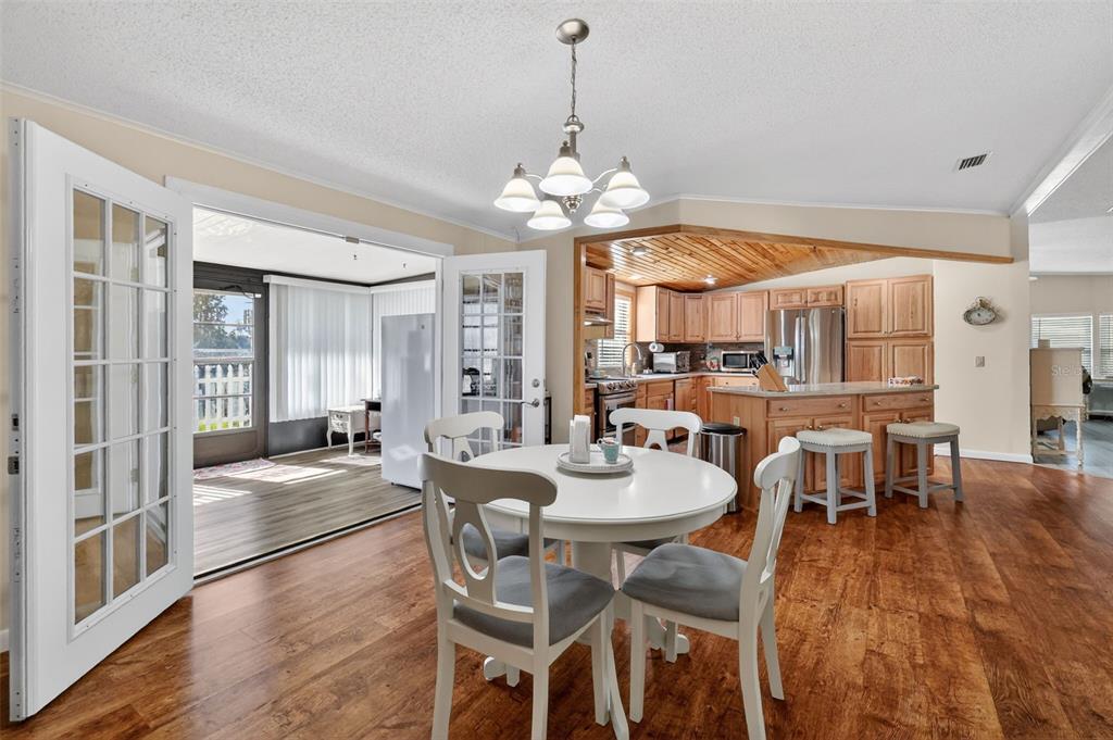 3567 Manatee Road Tavares, FL 32778 - Photo 22 of 67 a view of a dining room with furniture window and wooden floor