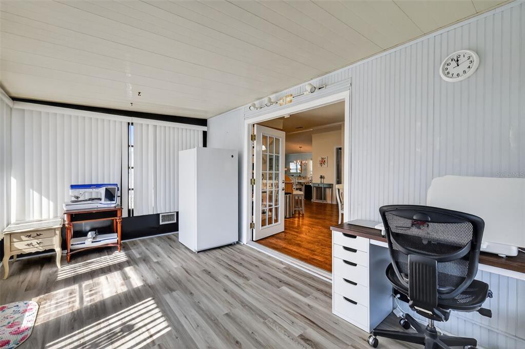 3567 Manatee Road Tavares, FL 32778 - Photo 23 of 67 a view of a workspace with furniture and wooden floor