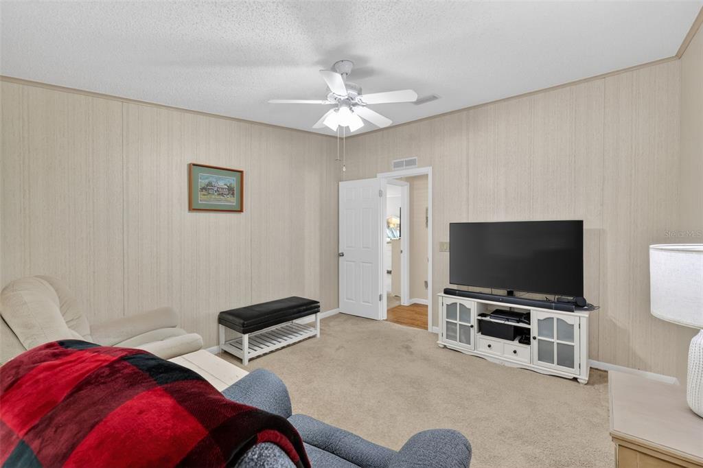 3567 Manatee Road Tavares, FL 32778 - Photo 27 of 45 a living room with furniture and a flat screen tv
