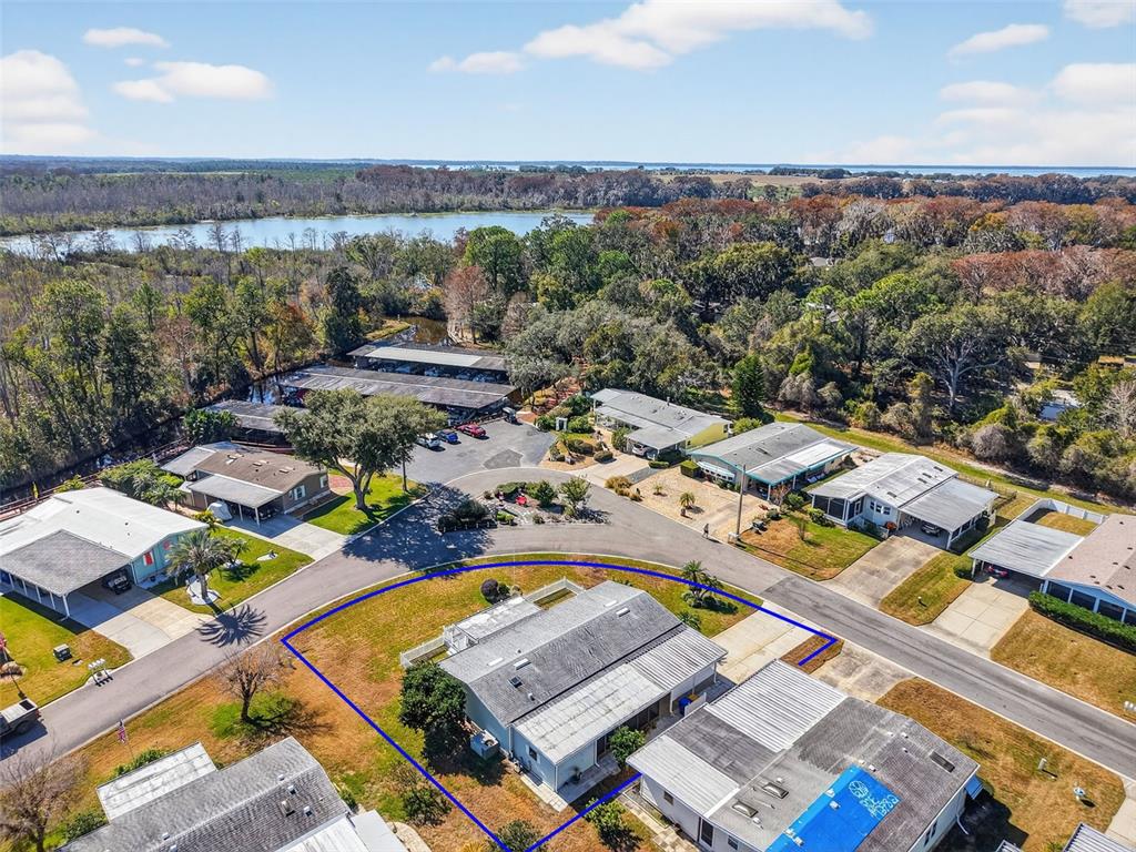 3567 Manatee Road Tavares, FL 32778 - Photo 28 of 67 an aerial view of a city with lots of residential buildings and mountain view in back