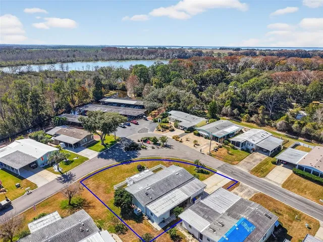 an aerial view of a city with lots of residential buildings and mountain view in back