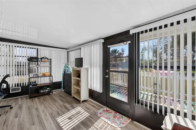 a view of a bedroom with furniture and window