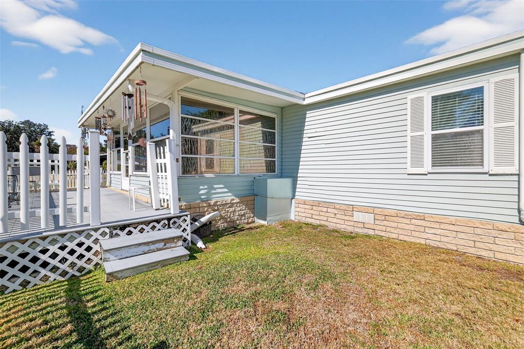 3567 Manatee Road Tavares, FL 32778 - Photo 35 of 45 a view of a house with a large window and wooden fence