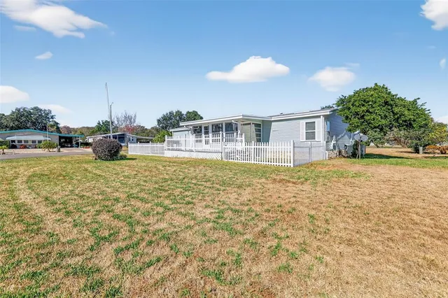 a view of a house with a yard and sitting area