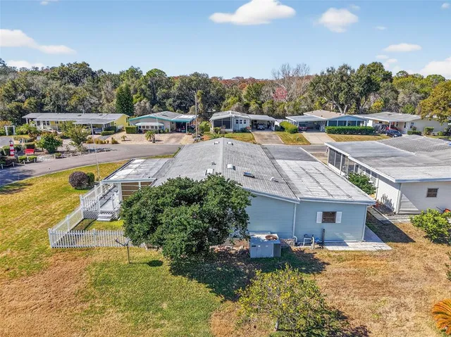 a view of a house with a yard pool and outdoor seating