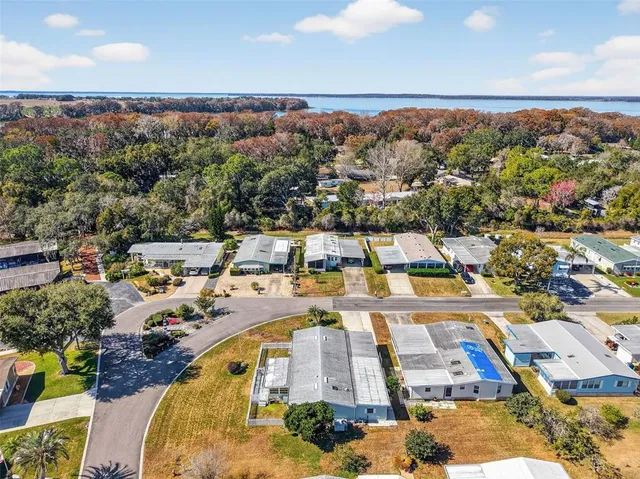 an aerial view of a house with yard swimming pool and outdoor seating