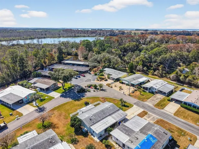 an aerial view of a city with lots of residential buildings and mountain view in back