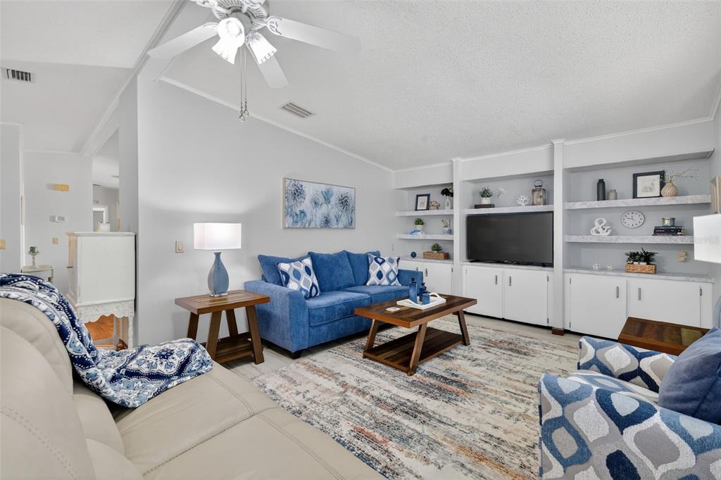 3567 Manatee Road Tavares, FL 32778 - Photo 5 of 67 a living room with furniture a flat screen tv and a window
