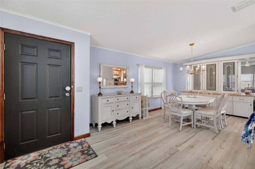 3567 Manatee Road Tavares, FL 32778 - Photo 6 of 45 a dining room with furniture and window