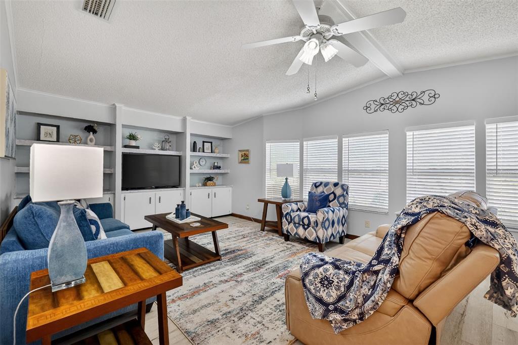 3567 Manatee Road Tavares, FL 32778 - Photo 9 of 45 a living room with furniture and a flat screen tv