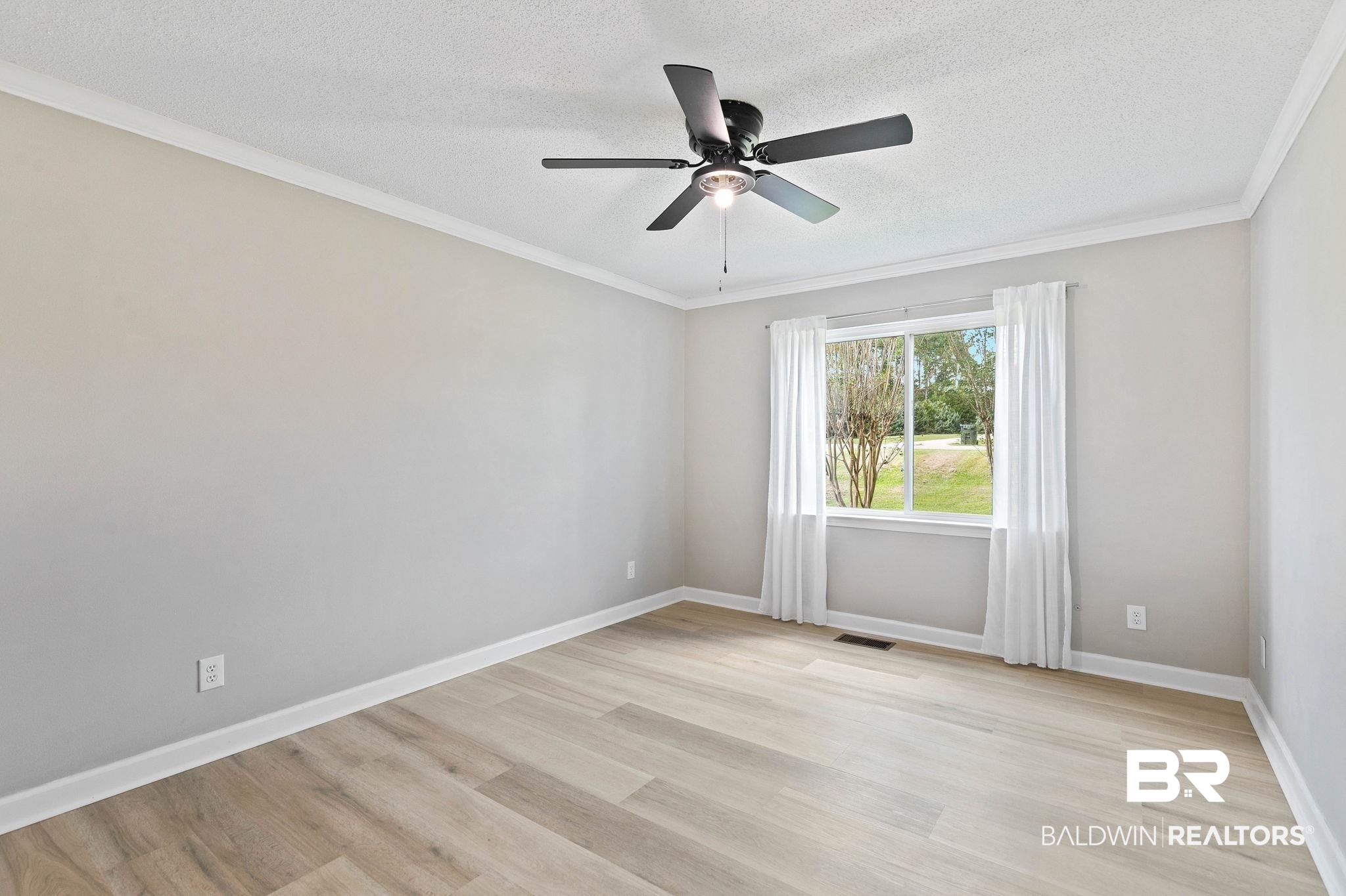 35650 Spring Road North Stapleton, AL 36578 - Photo 47 of 70 Empty room featuring ornamental molding, light wood-type flooring, a textured ceiling, and ceiling fan