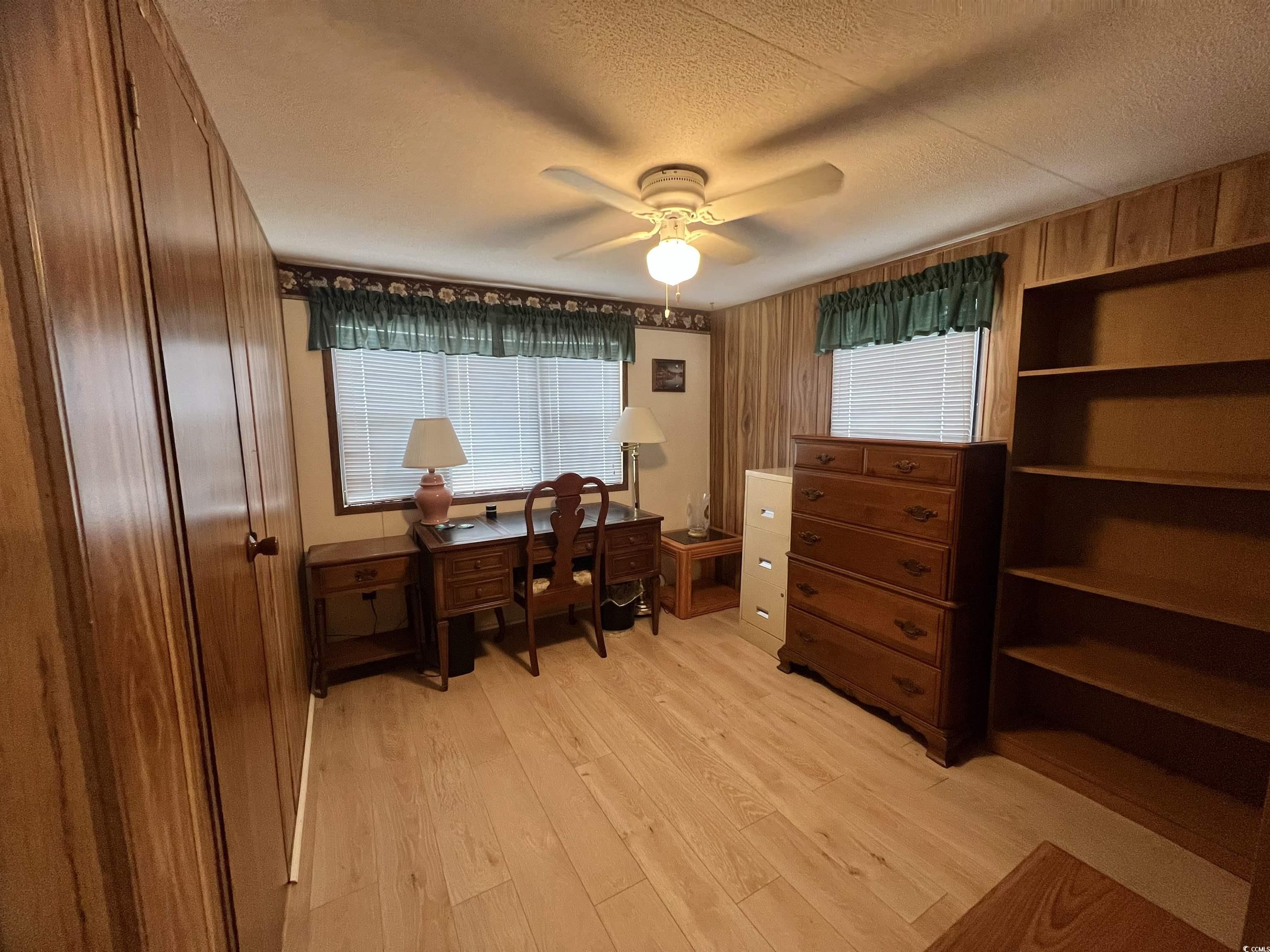 54 Crooked Island Circle Murrells Inlet, SC 29576 - Photo 10 of 37 Office space with wooden walls, light wood-style flooring, healthy amount of natural light, ceiling fan, and a textured ceiling