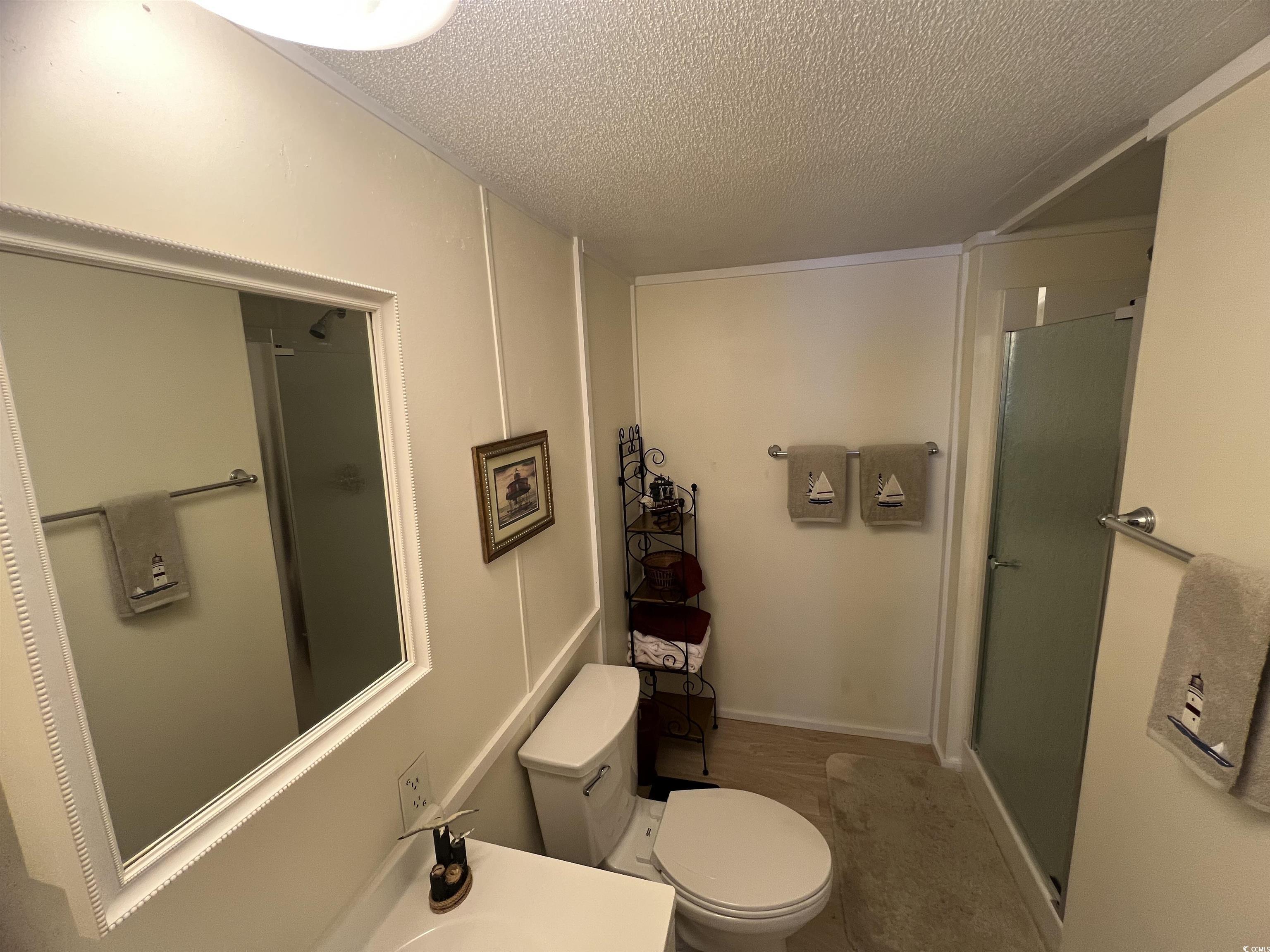 54 Crooked Island Circle Murrells Inlet, SC 29576 - Photo 18 of 37 Bedroom with a textured ceiling and light wood-style floors