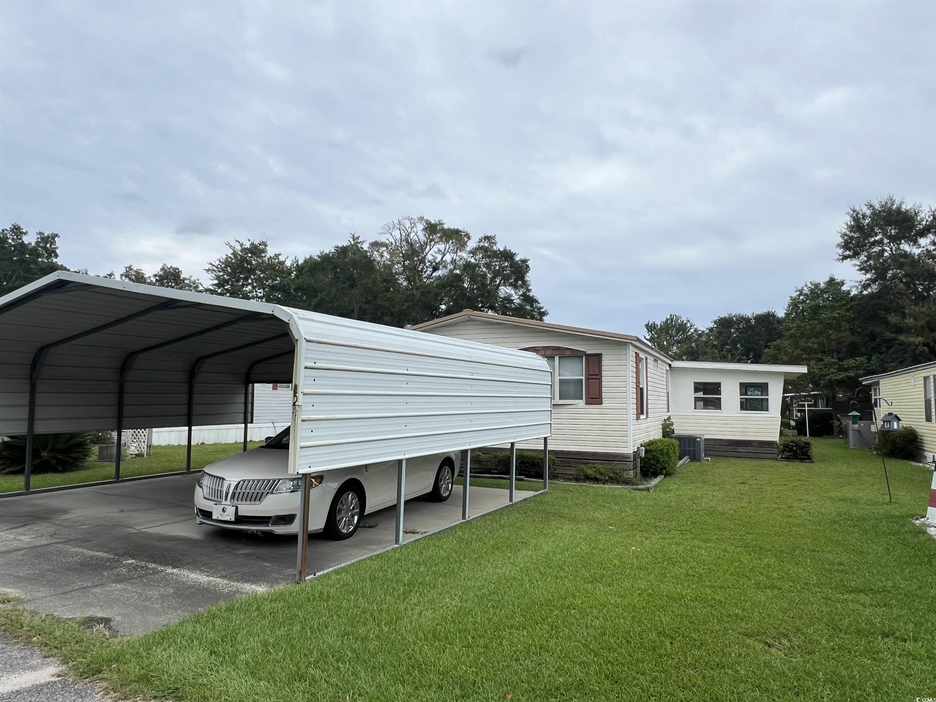 54 Crooked Island Circle Murrells Inlet, SC 29576 - Photo 2 of 37 View of parking with a carport and driveway