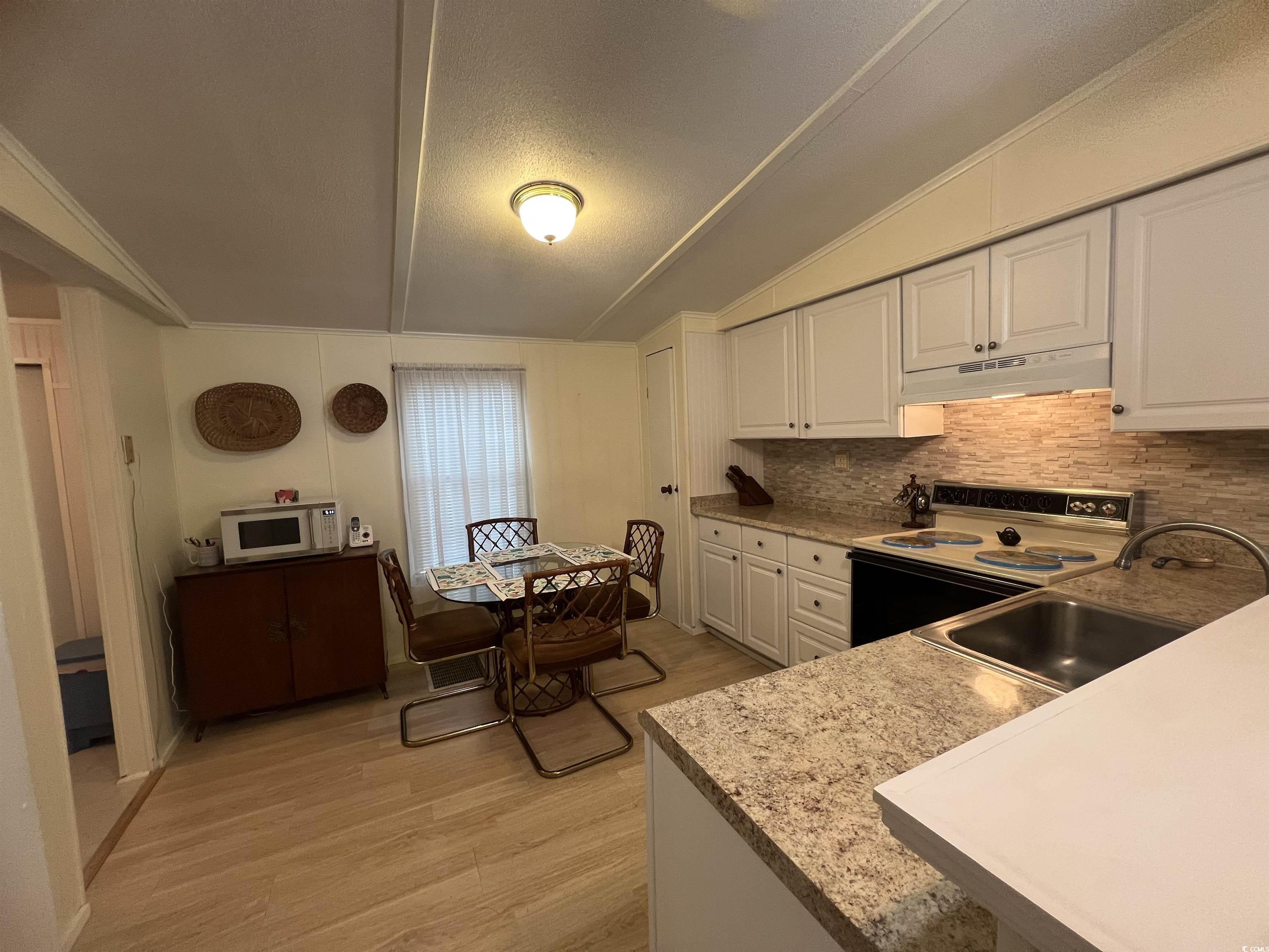 54 Crooked Island Circle Murrells Inlet, SC 29576 - Photo 20 of 37 Home office featuring light wood-type flooring, a textured ceiling, wooden walls, and a ceiling fan