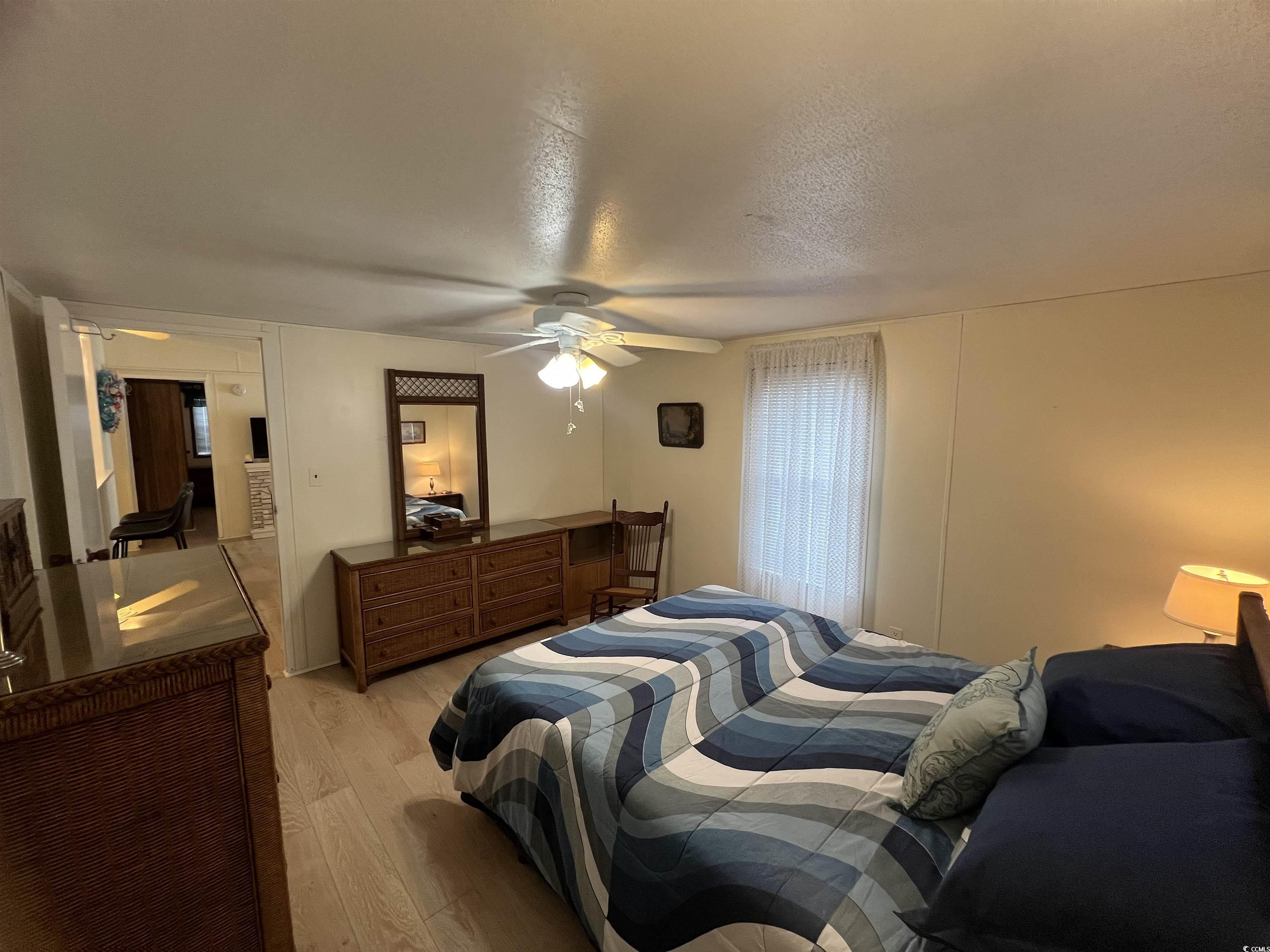 54 Crooked Island Circle Murrells Inlet, SC 29576 - Photo 26 of 37 Bedroom with light wood finished floors, a textured ceiling, and ceiling fan