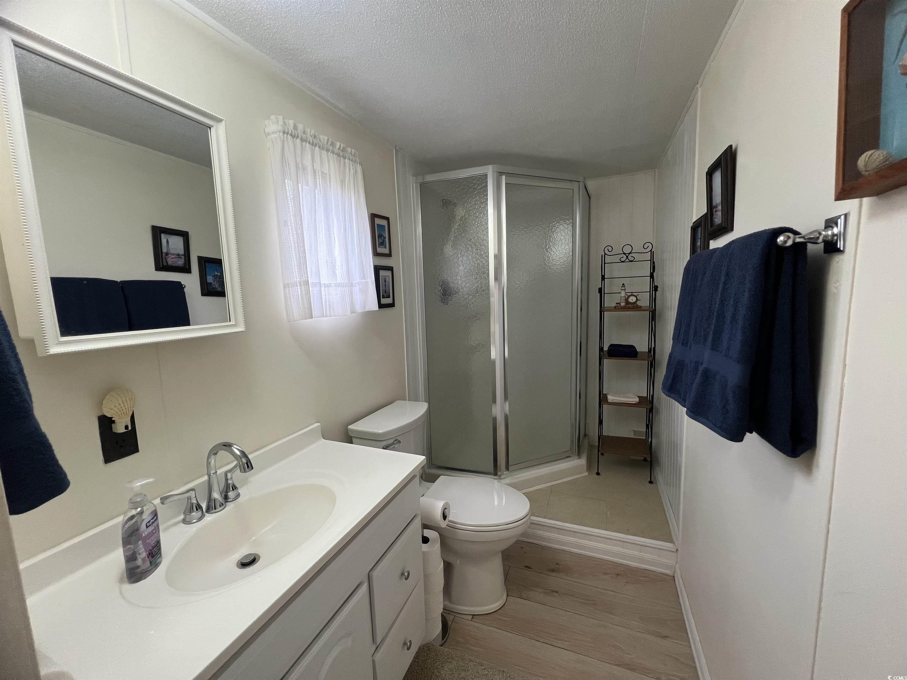 54 Crooked Island Circle Murrells Inlet, SC 29576 - Photo 27 of 37 Bedroom featuring light wood-style floors, ceiling fan, and a textured ceiling