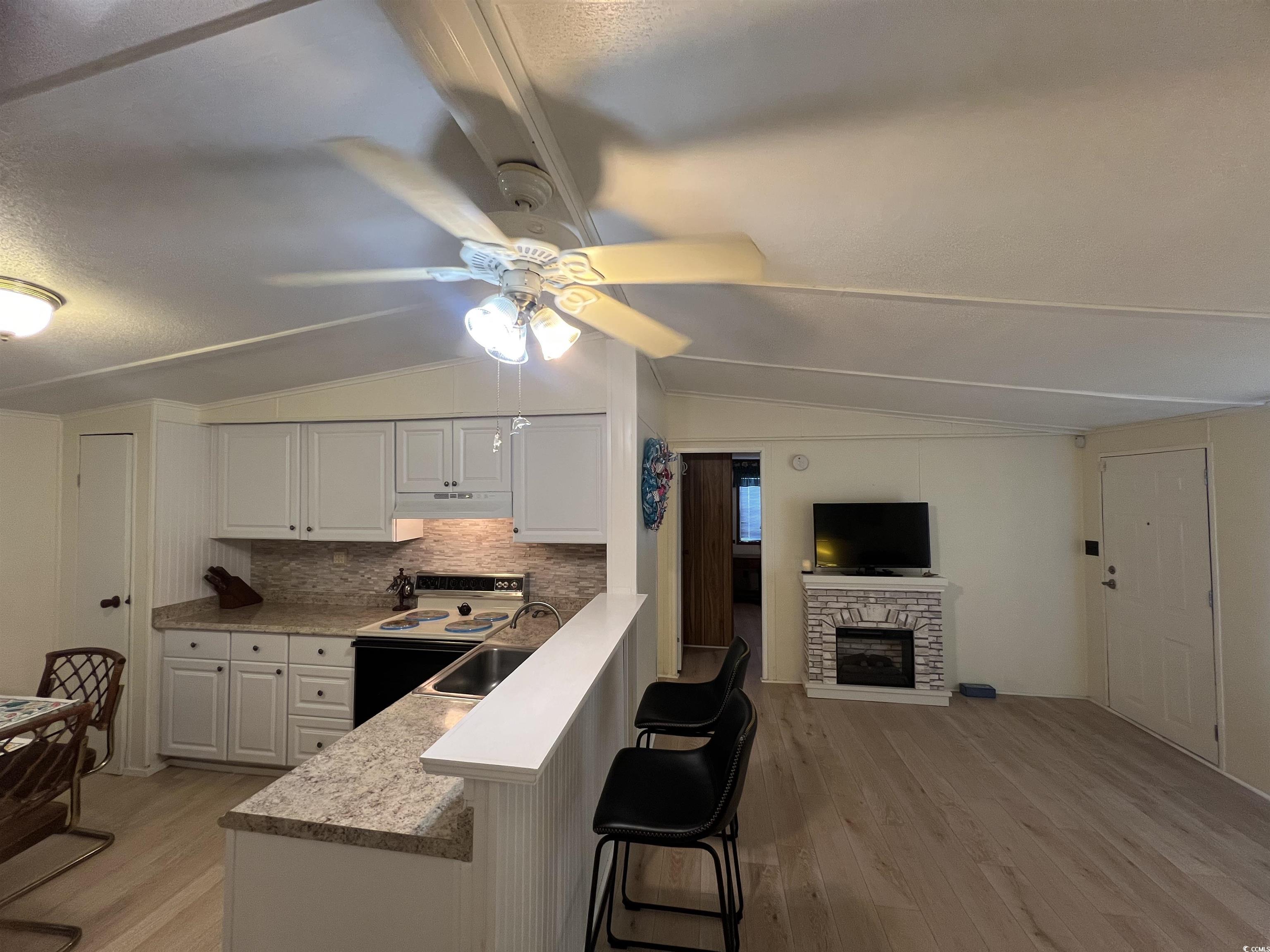54 Crooked Island Circle Murrells Inlet, SC 29576 - Photo 28 of 37 Bathroom with a textured ceiling, vanity, light wood finished floors, and a stall shower