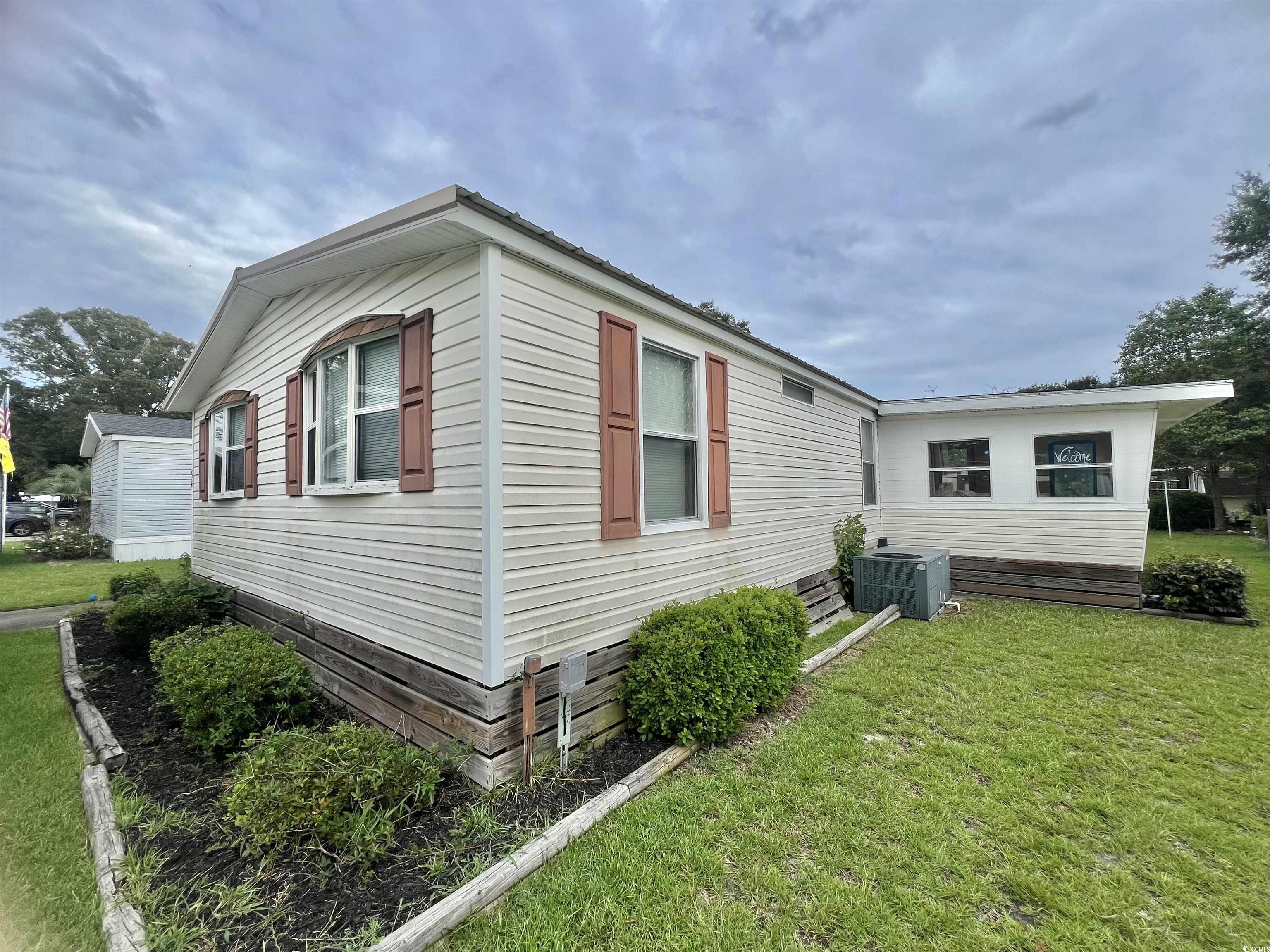 54 Crooked Island Circle Murrells Inlet, SC 29576 - Photo 3 of 37 View of home's exterior with a yard and a cooling unit