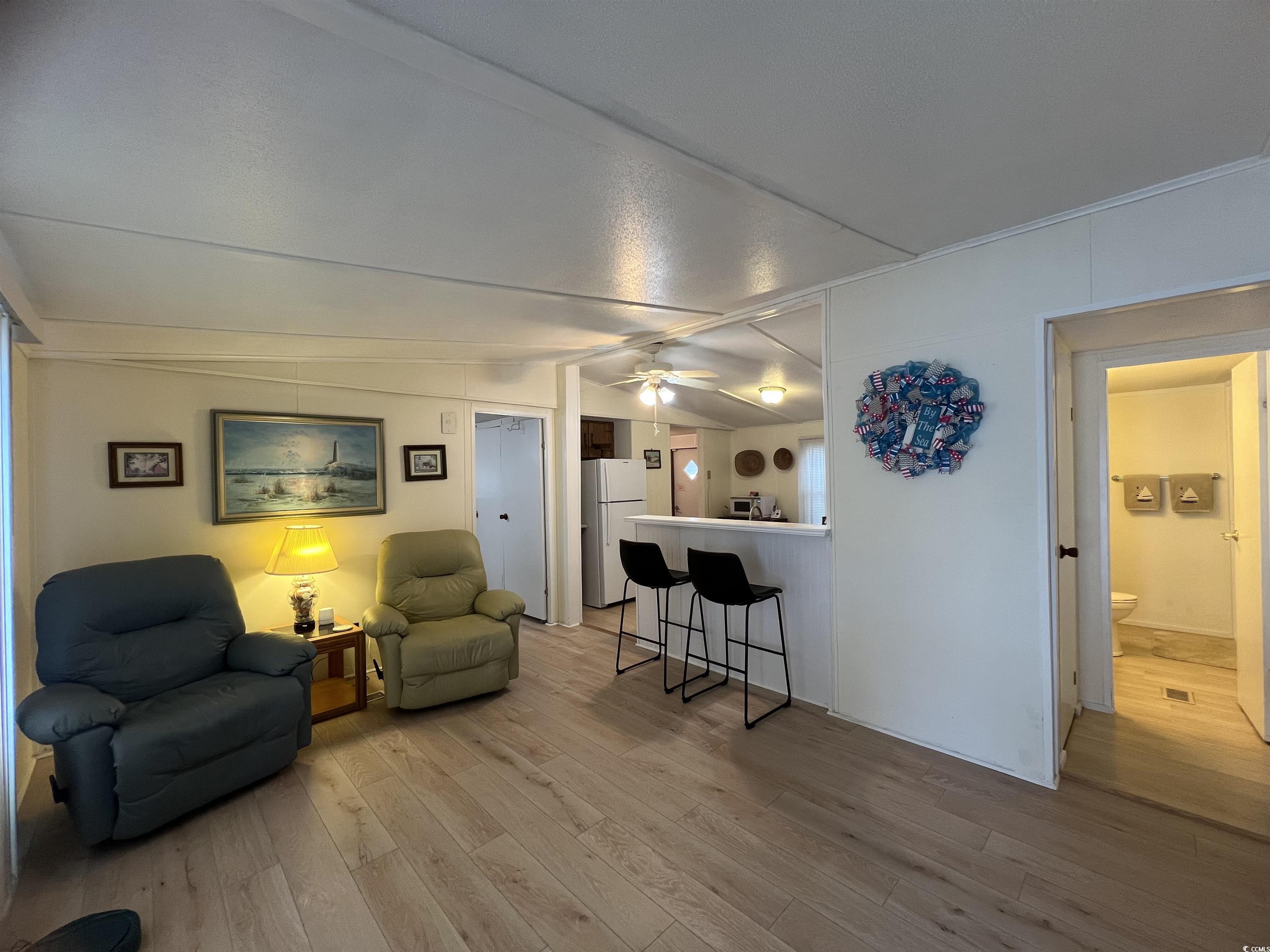 54 Crooked Island Circle Murrells Inlet, SC 29576 - Photo 5 of 37 Living room featuring lofted ceiling and light wood-style floors