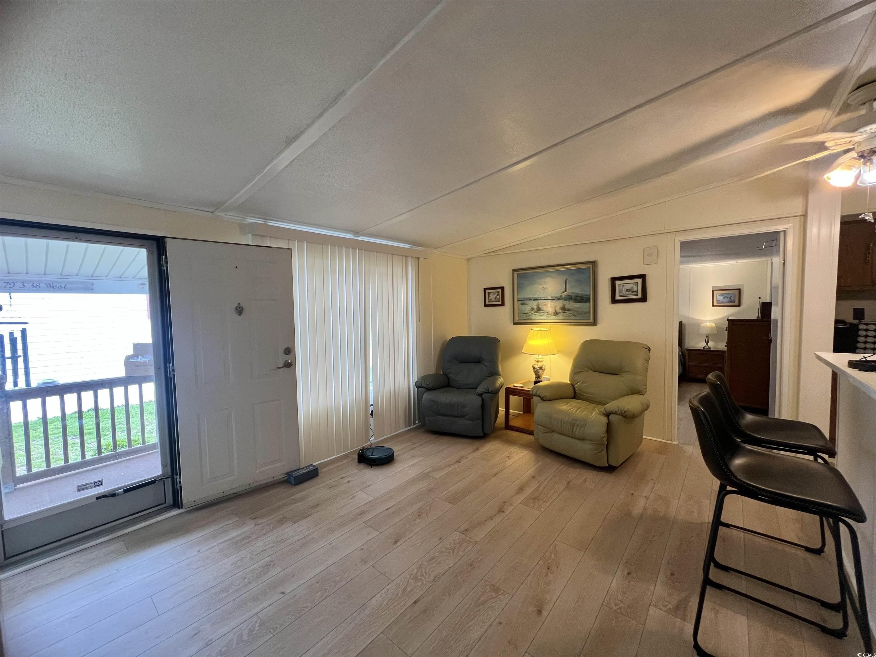 54 Crooked Island Circle Murrells Inlet, SC 29576 - Photo 6 of 37 Sitting room with light wood finished floors and vaulted ceiling