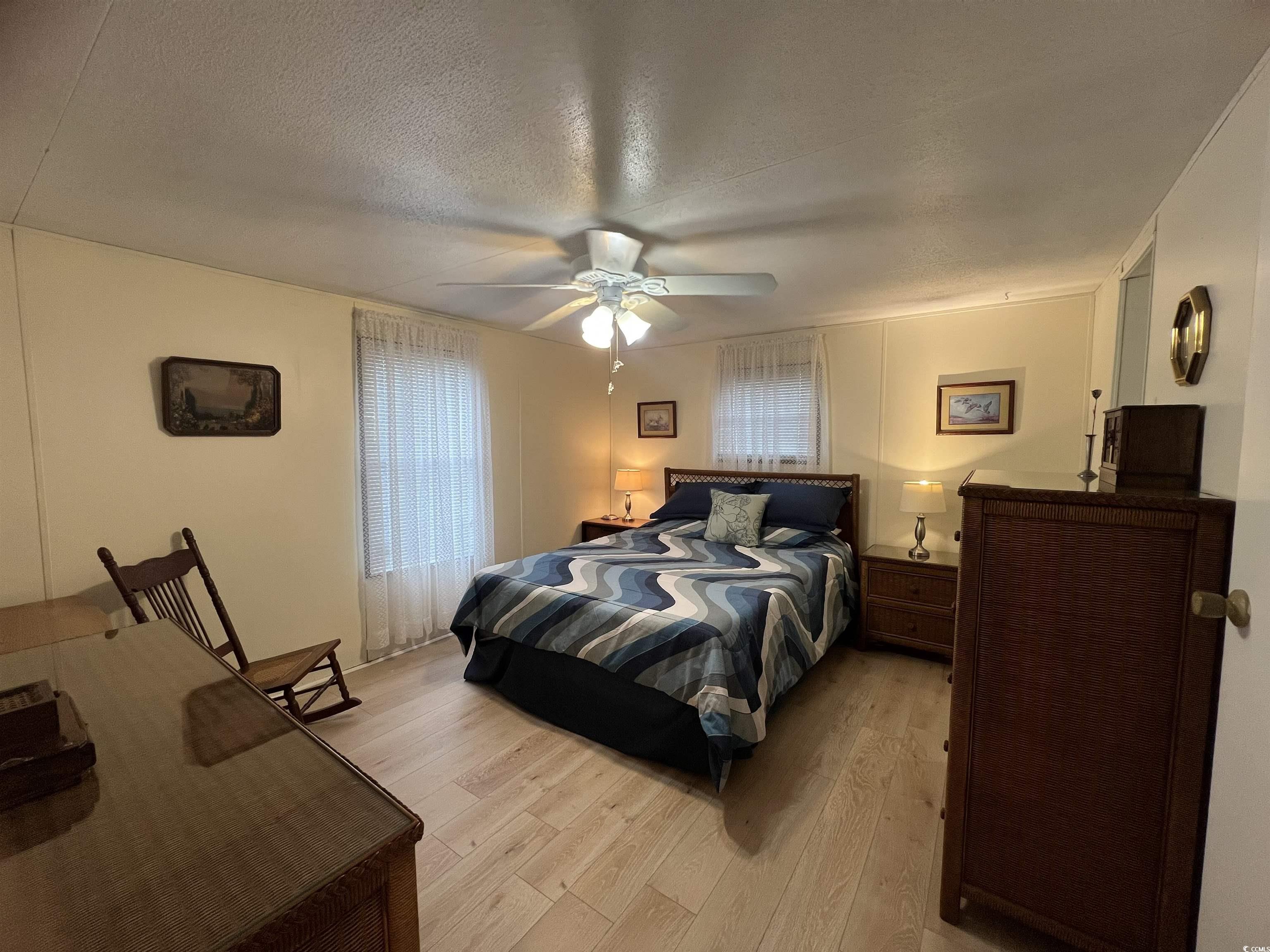 54 Crooked Island Circle Murrells Inlet, SC 29576 - Photo 8 of 37 Bedroom featuring light wood-style floors, a textured ceiling, and ceiling fan