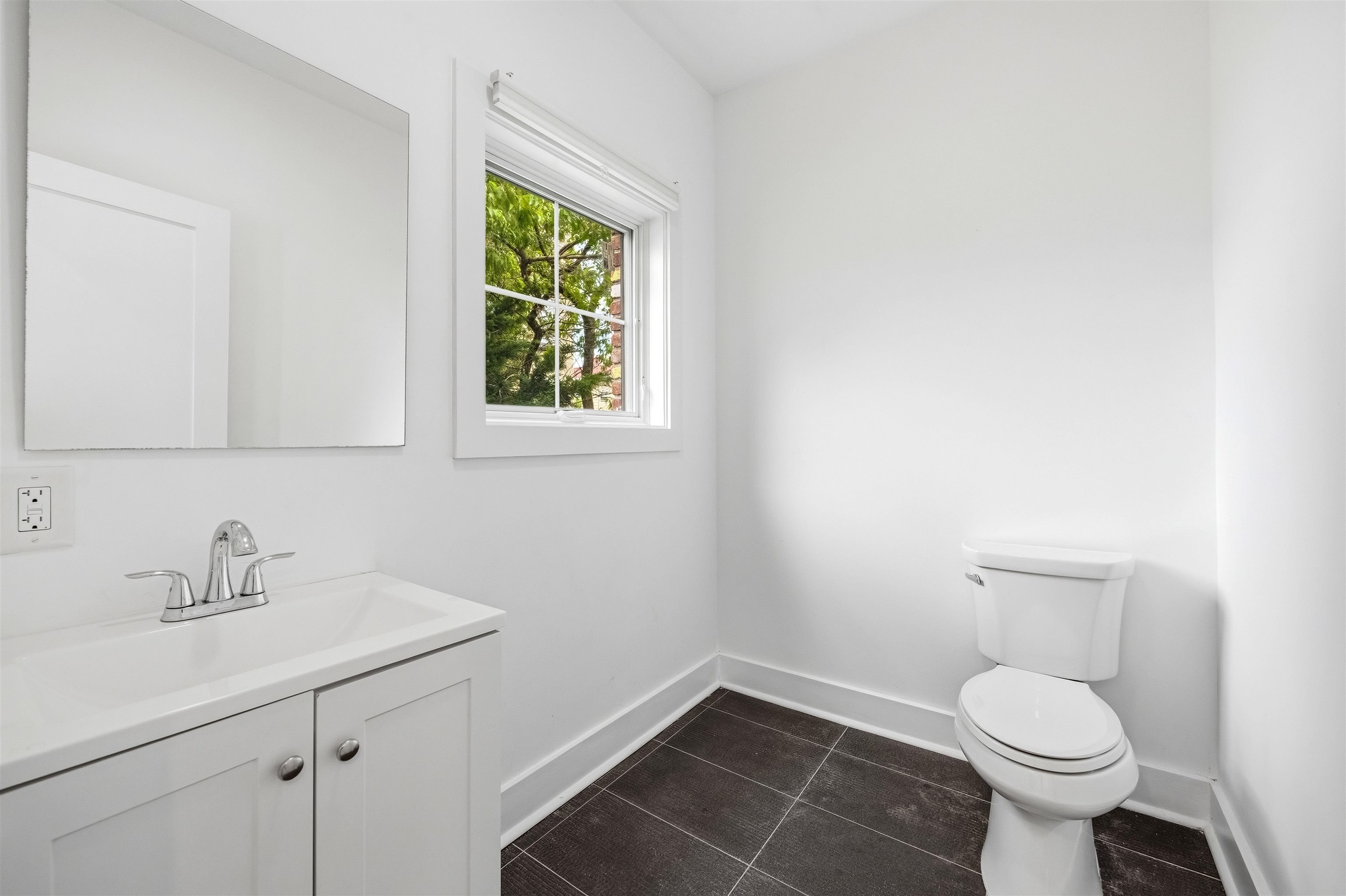 107 Mountain Road Jersey City, NJ 07307 - Photo 9 of 41 a bathroom with a sink toilet and a window