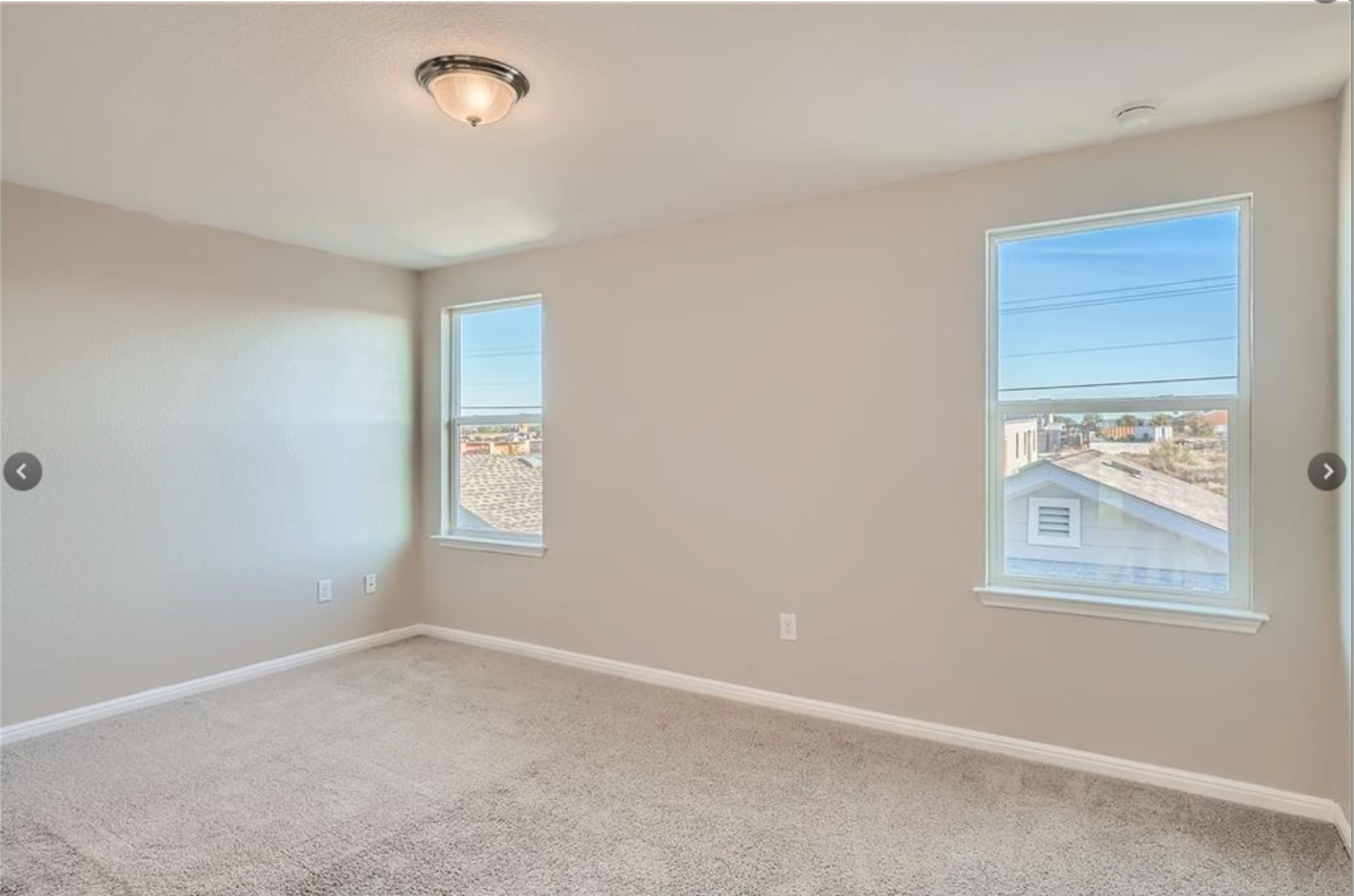 304 Cane River Road Pflugerville, TX 78660 - Photo 19 of 31 A well-lit, neutral-toned room provides a versatile canvas for personalized decor and comfortable living.