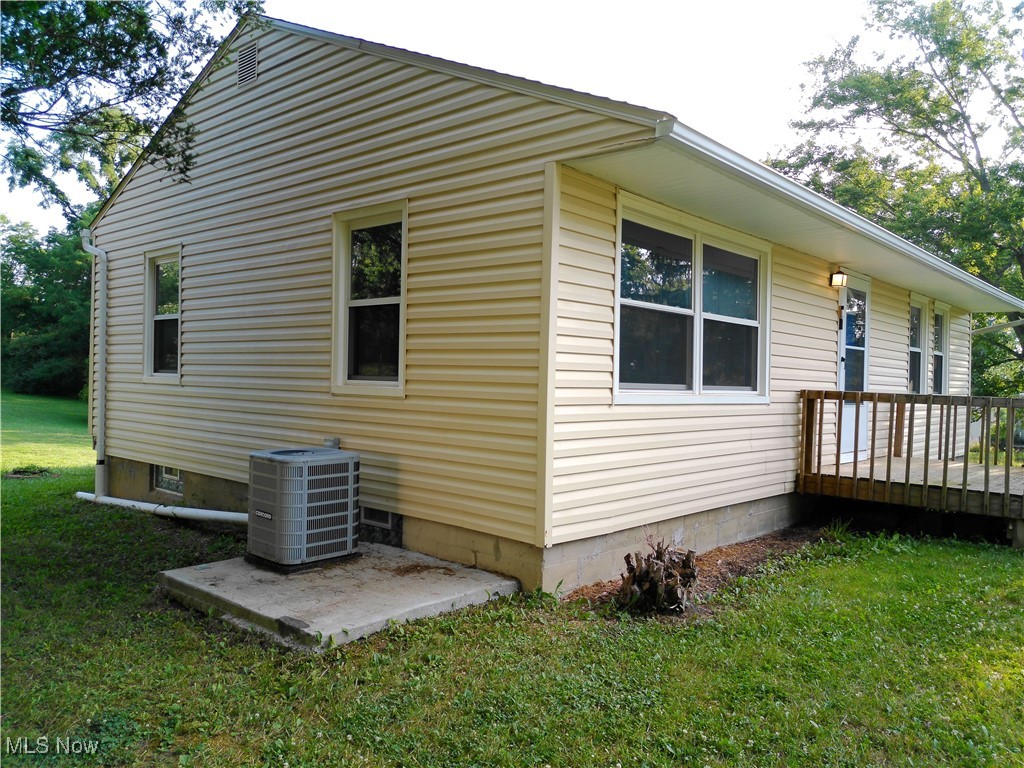 5476 Chippewa Road Medina, OH 44215 - Photo 4 of 30 View of side of home featuring a lawn and a wooden deck