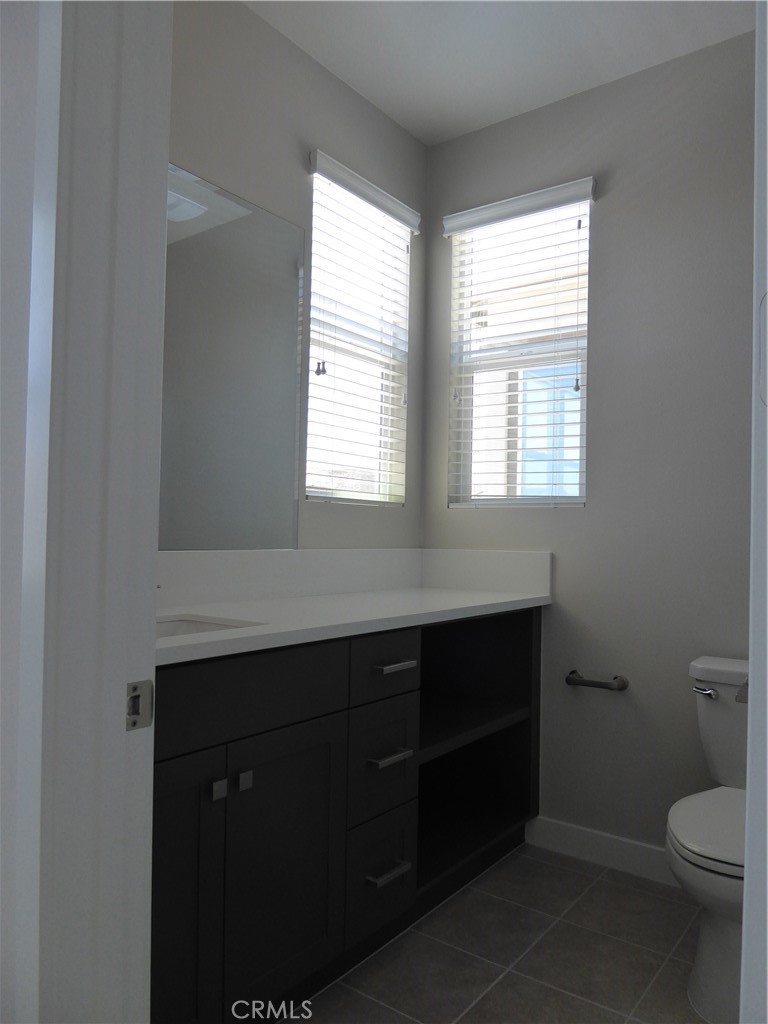 652 Athos Lake Forest, CA 92630 - Photo 11 of 13 a bathroom with a toilet sink and window