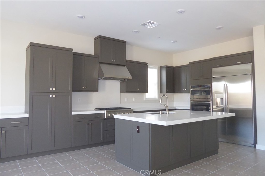 652 Athos Lake Forest, CA 92630 - Photo 2 of 13 a kitchen with stainless steel appliances a sink stove and cabinets
