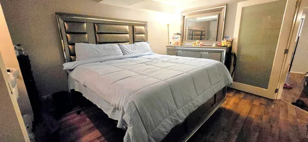 a bedroom with a bed and a mirror