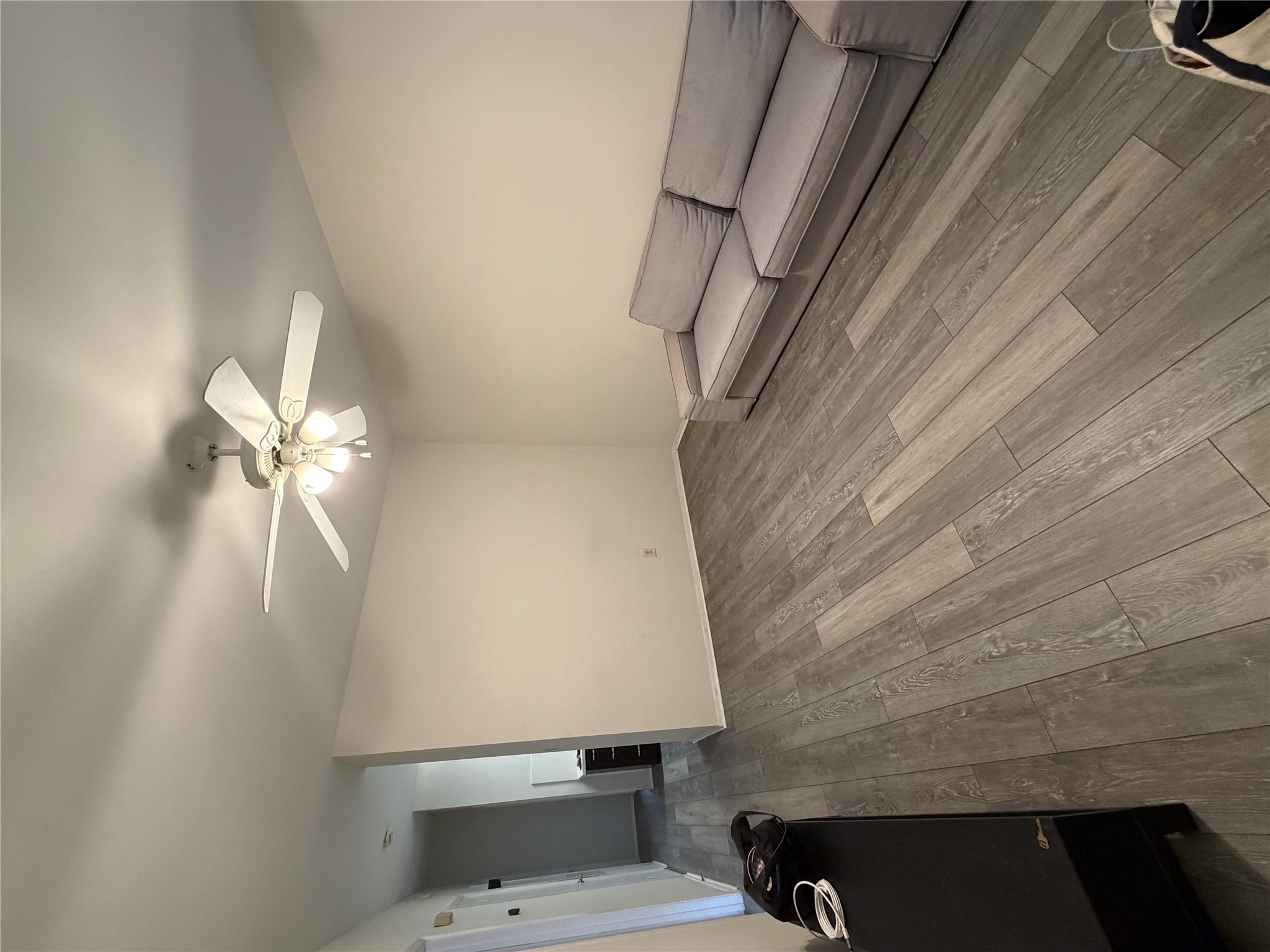 2801 Rio Grande Street, Unit 208 Austin, TX 78705 - Photo 2 of 8 Discover a spacious living room featuring resilient vinyl plank flooring and an overhead ceiling fan.