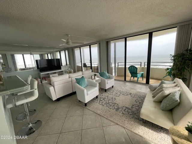 a view of a dining room with furniture and window