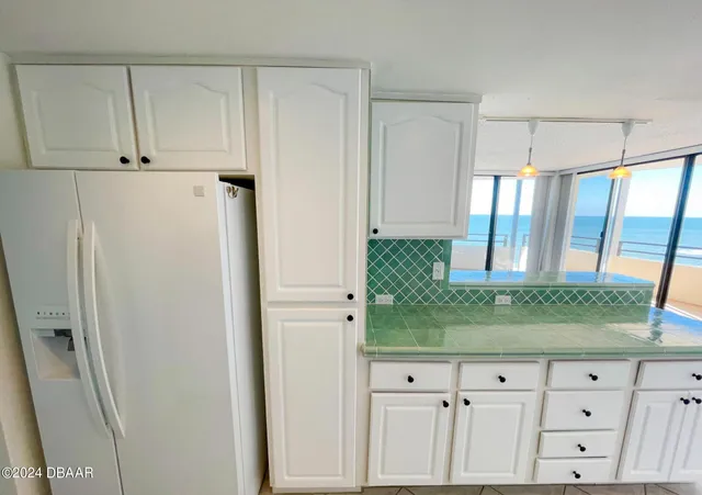 a kitchen with a cabinets and white appliances