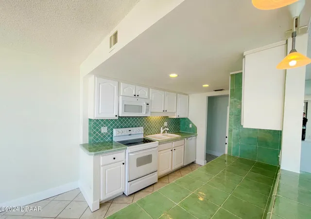 a large white kitchen with a large window