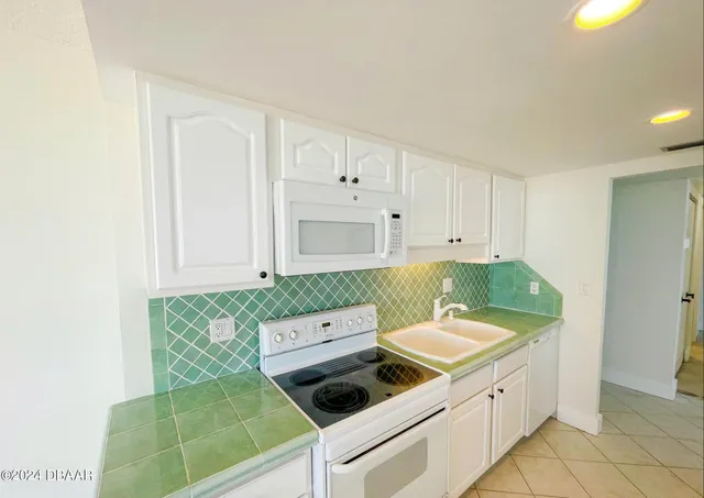 a spacious bathroom with a tub sink and a mirror