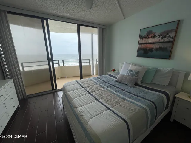 a bedroom with a bed and a tv